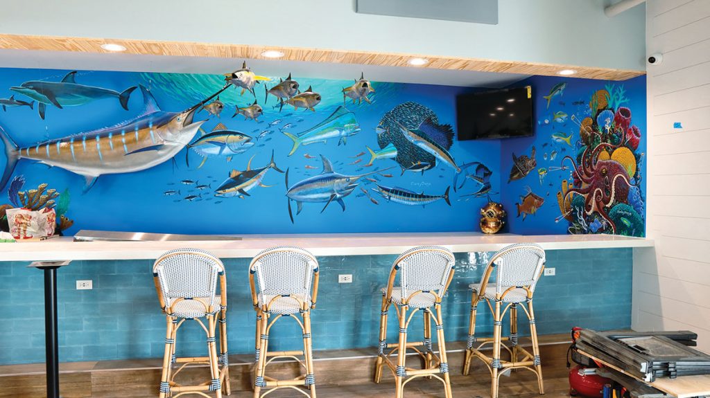 Renowned local marine artist Carey Chen painted this mural inside the restaurant. Photography by Fernando Vega