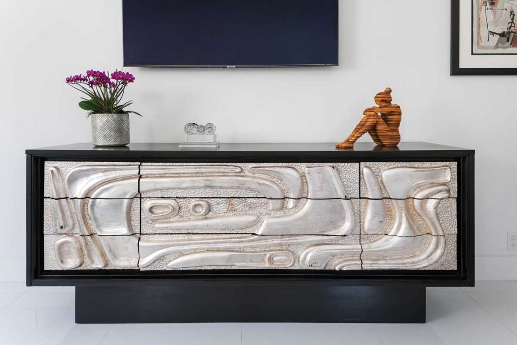 A brutalist mid-century silver-leaf ebonized credenza in the master bedroom.