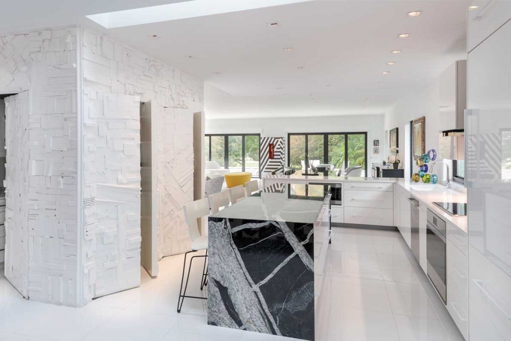 The sleek kitchen, with a marble island, opens to the great room.