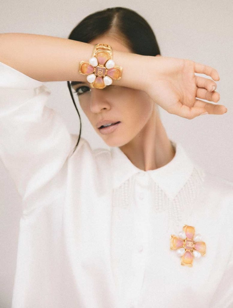 Metal, resin brooch ($1,350) and cuff ($1,750), Chanel, The Gardens Mall, Palm Beach Gardens; white blouse stylist’s own