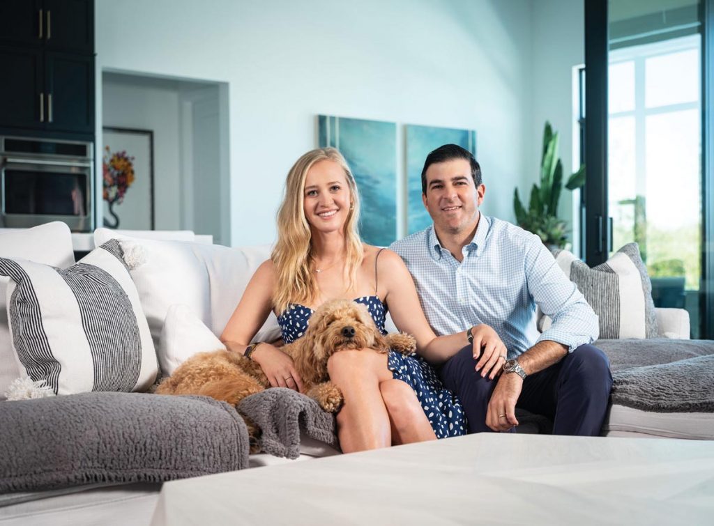 The couple at home with their adorable dog, Charlie. Photography by Ben Rusnak