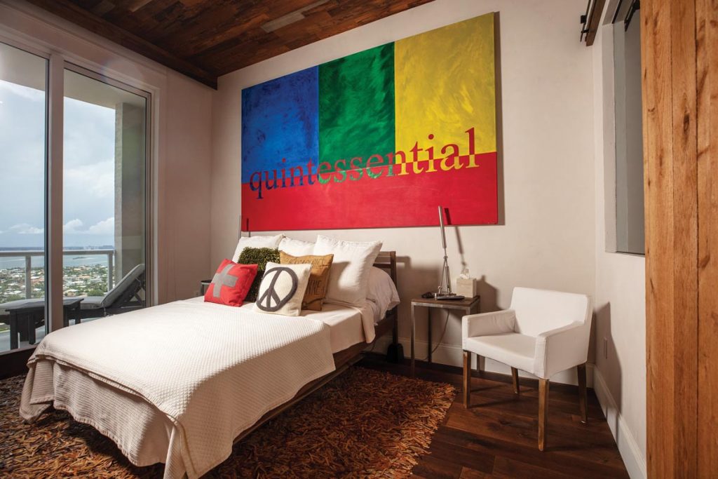 A large, colorful painting by Holland (2008) hangs in the guest bedroom. Photo by Benjamin Rusnak