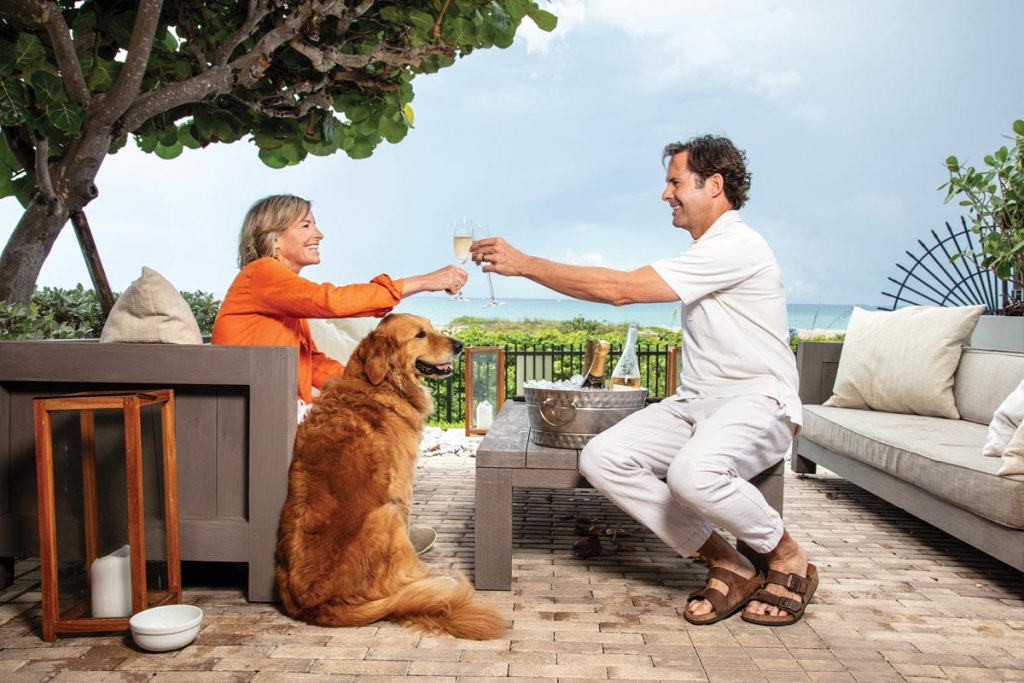 Kaye and Holland with Gatsby outside the beach cabana they own at their residence. Photo by Benjamin Rusnak