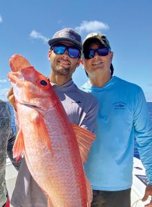 Riley and his dad, Mike, with a queen snapper. Photo by George LaBonte