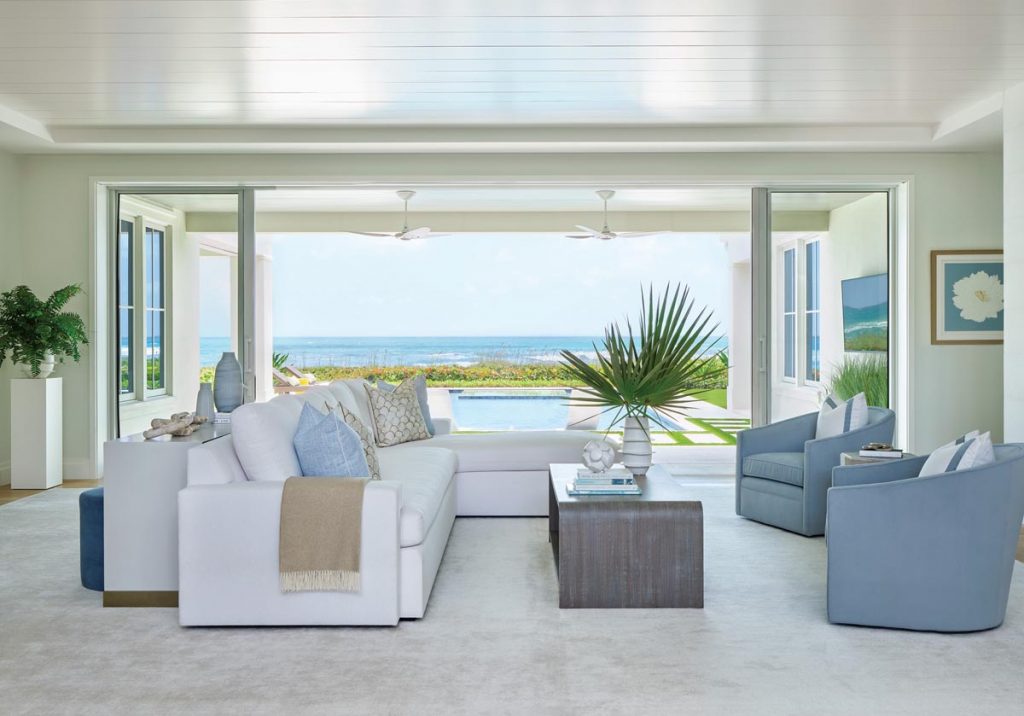 Ultra-suede upholstery, pale blues, and neutrals create a calm and inviting space in the great room. Photo by Carmel Brantley