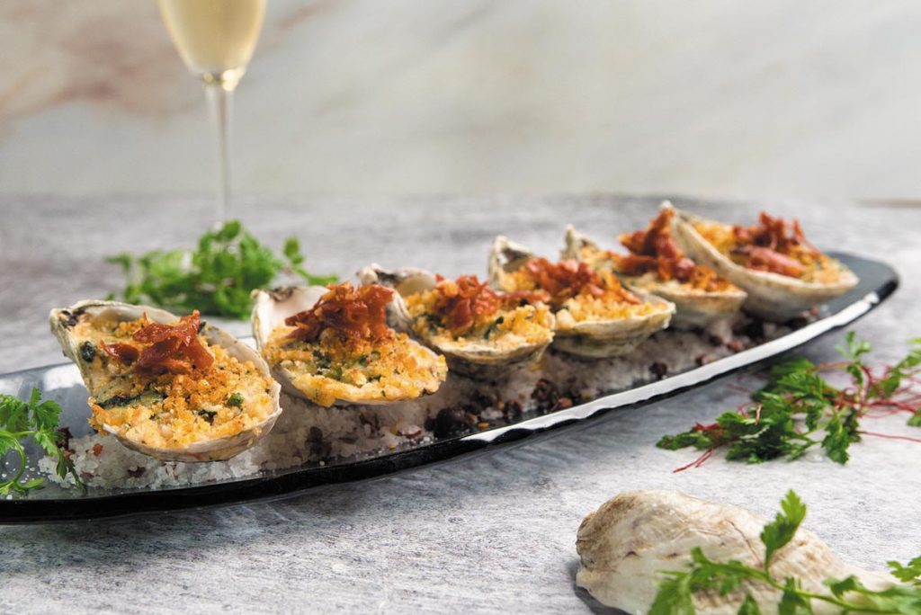 Enjoy oysters Rockefeller during Social Hour at 1000 North. Photo by Michael Albanese