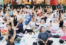 Namaste at The Gardens Returns in July Puppy Yoga returns to The Grand Court July 25. Photo courtesy of The Gardens Mall