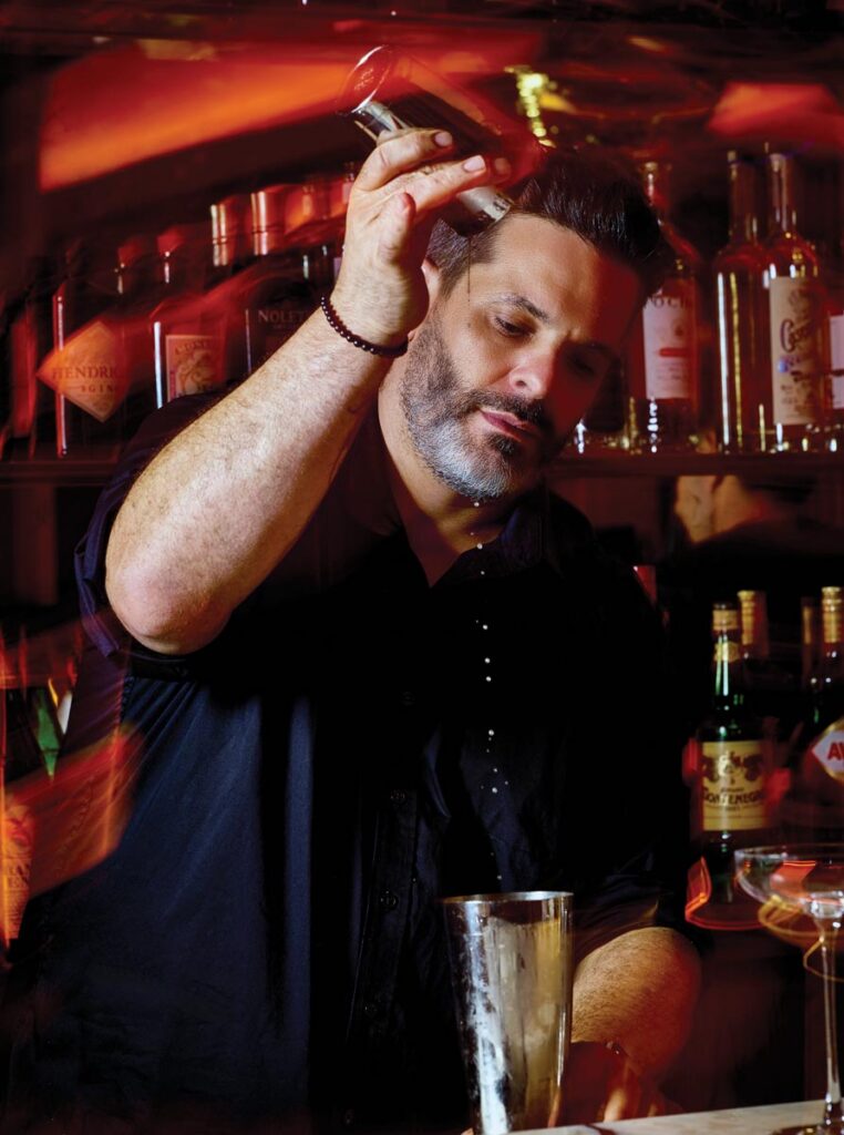 Armando Conway prepares a cocktail at Stanza Lounge. Photo by Eleven photography