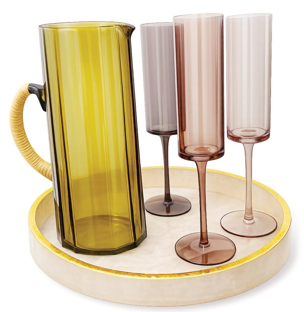 Ivory resin round serving tray ($58), Venus Champagne flutes ($20 each), hammered pitcher ($68)
